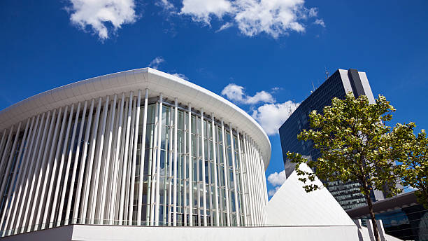 Panoramic picture of the modern buildings on Kirchberg in a park with a tree on the right side