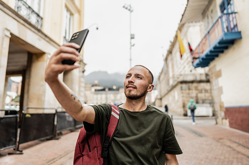 Traveler young man taking a selfie at historic district of Bogota, Colombia