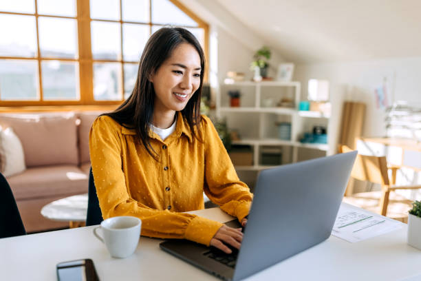 istock Young beautiful woman using laptop at home 1791148730
