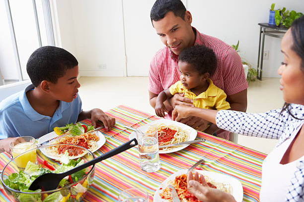 istock A family eating a meal around the dining table 179115534
