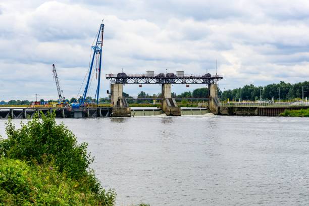 istock a crane is lifting construction and water off the ground next to a lake 1791157231
