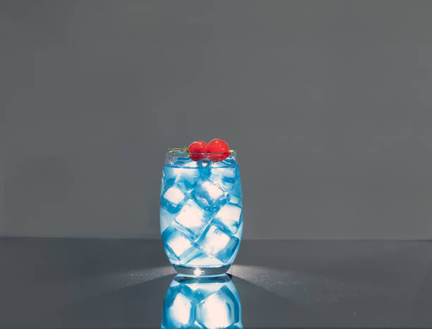 istock Backlit Blue Drink with Maraschino Cherries on a dark background 1791168988