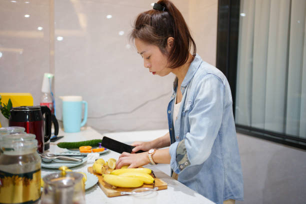 istock The woman cutting bananas 1791169533