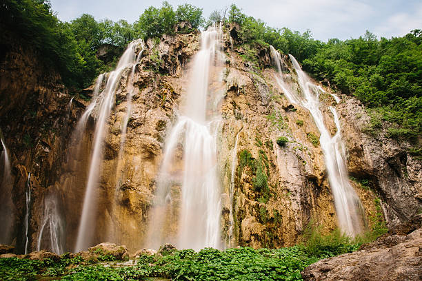 waterfall in forest with slow shutter motion stock photo