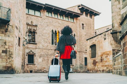 Solo traveller with suitcase walking at the street in Barcelona