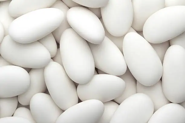 close up of a group of white sugared almonds