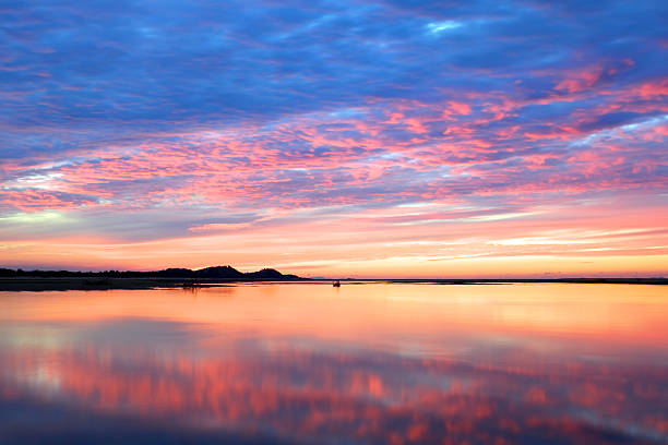 Vibrant sunset over water stock photo
