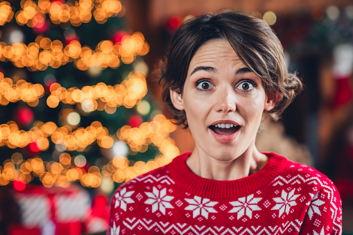 Portrait of funny young surprised girl bob brown hair unbelievable magic fairy winter season christmas tree isolated indoors background.