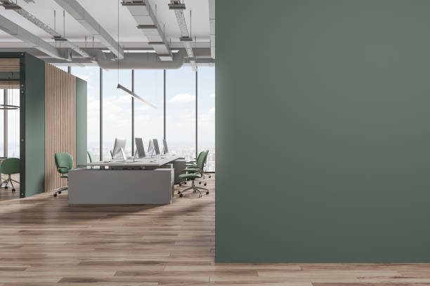 istock Green workspace interior with pc computers on table and chairs, mock up wall 1791181581