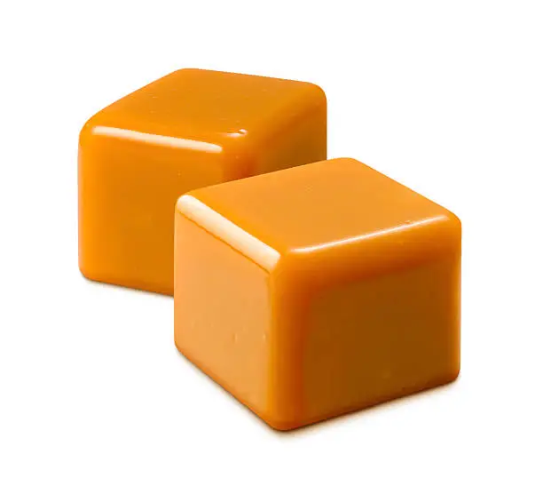  Two cubes of Caramel Candy. The image is shown at an angle, and is in full focus from front to back.