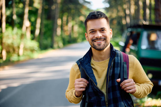 istock Happy man on camping trip in nature looking at camera. 1791189199