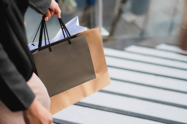 istock hand holding a shopping bag 1791190480