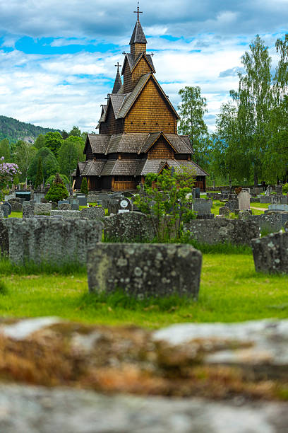 Heddal Church in Norway A dimensional shot with a wall and beyond the stave church of Heddal. heddal stock pictures, royalty-free photos & images