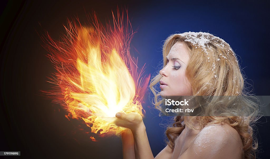 Frozen girl hold a falme in palms Frozen girl hold a falme in palms (big flame) Ice Stock Photo