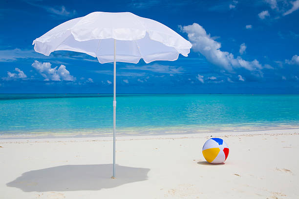 istock white sunshade and ball at the beach 179120096