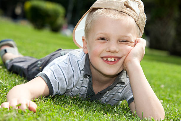 istock happy child lying on the grass 179120273