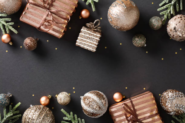 istock Christmas frame with elegant bronze accents. Modern design featuring festive elements like baubles, gifts, and confetti. Luxury holiday composition on a dark background. Ideal for greeting cards 1791202833