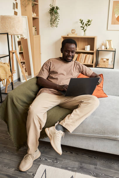 istock Young African American man using laptop at home and relaxing 1791203330
