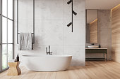 White marble and wooden bathroom interior with tub and sink