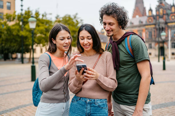 istock Three Young Friends Using Smart Phone On The Stortorget Square In Malmo In Sweden 1791212947