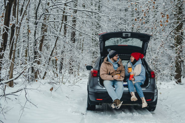 istock In a snowy winter forest, a couple drinks coffee in their trunk 1791213006