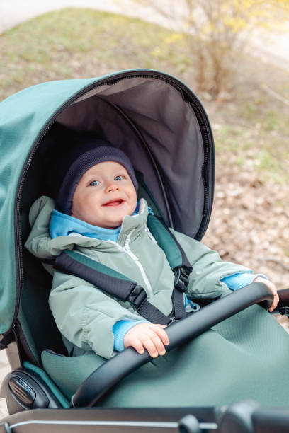 istock Smiling baby child in a stroller in the spring park 1791213209