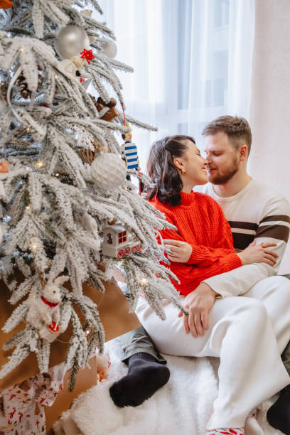 istock beautiful couple near christmas tree 1791213538