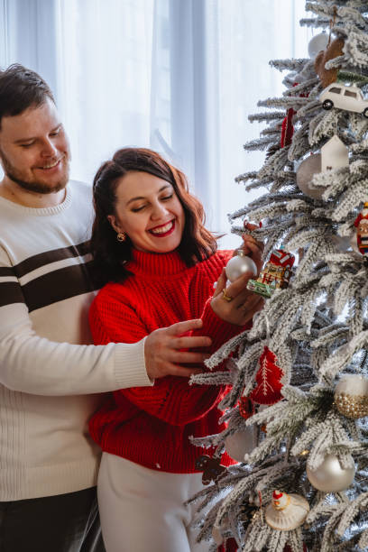 istock couple together decorating christmas tree 1791213546