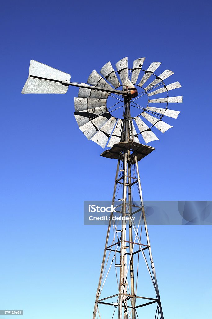 Old windmill against a blue sky An old windmill against a blue sky in the town of Sutherland of Northern Cape of South Africa Abandoned Stock Photo