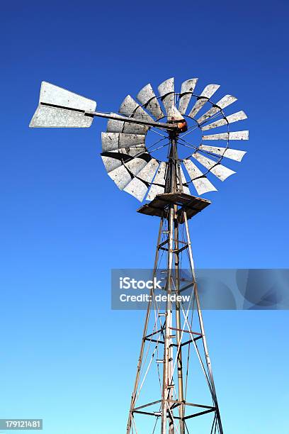 Old Windmill Against A Blue Sky Stock Photo - Download Image Now - Abandoned, Agriculture, Black And White