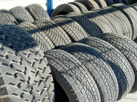 Used car tires. Rubber wheel tires. Recycling of old worn-out truck tires. Background