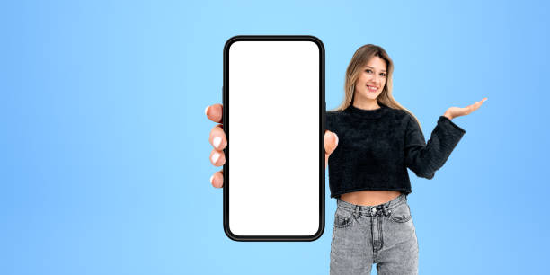 istock Smiling woman showing phone with blank display 1791216346