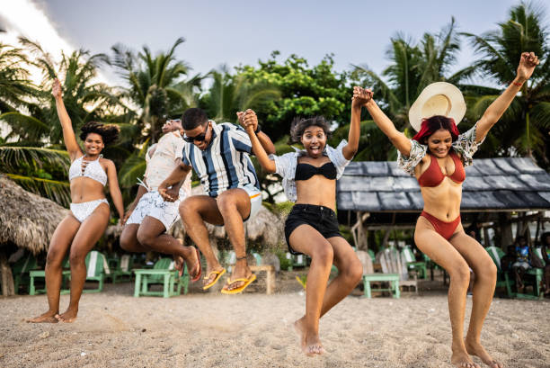 Young friends jumping at the beach