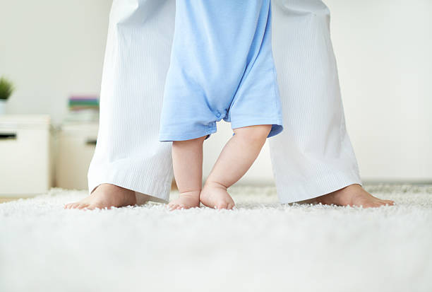 istock Baby in blue onesie taking first steps 179121961
