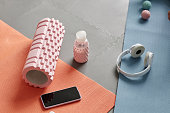 Top View of Pink Foam Roller and Sports Workout Accessories on Floor