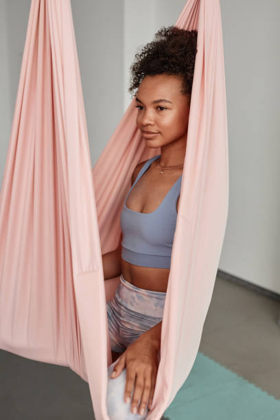 istock Black woman sitting in pink hammock 1791228393