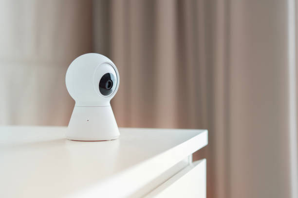 istock Selective focus of Smart home wireless security camera set up on white table at home 1791239603