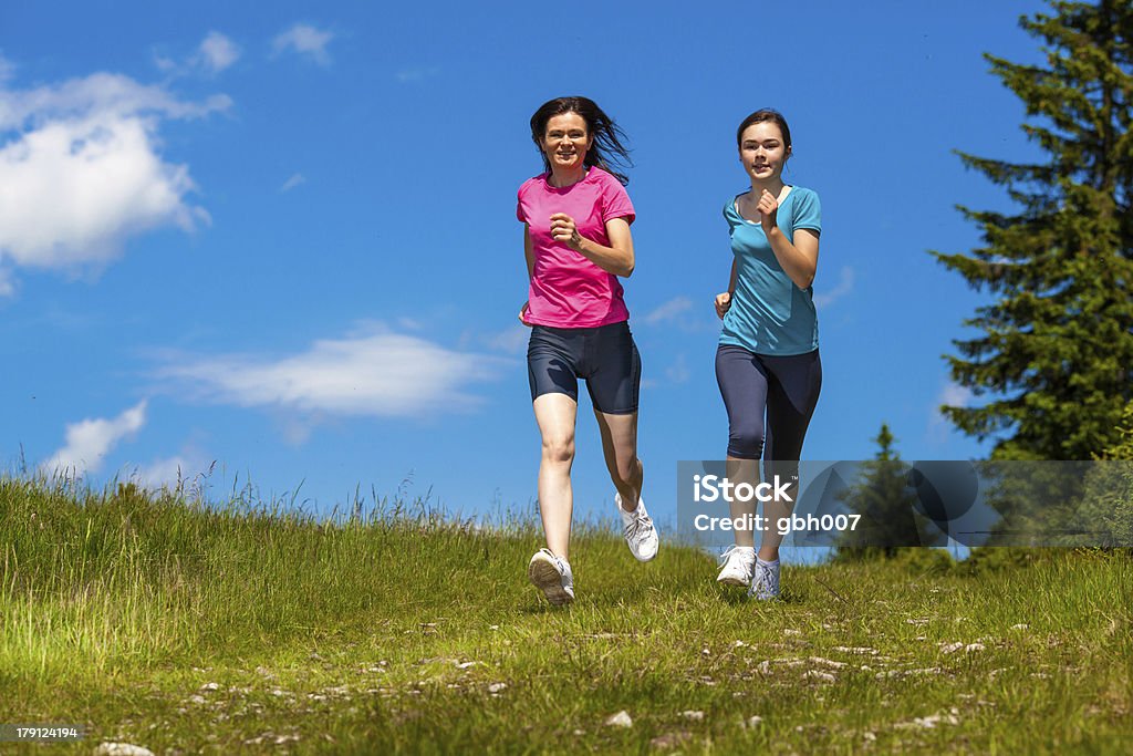 Women running outdoor Summer joy - family running outdoor Daughter Stock Photo