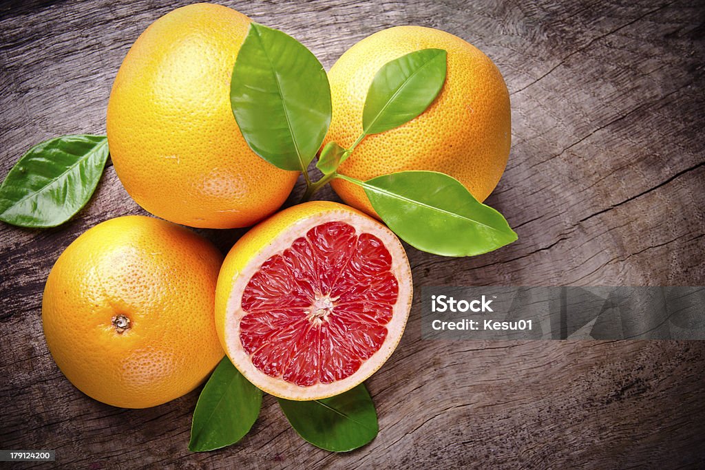 freshly harvested grapefruit Freshly harvested grapefruit on wooden background Close-up Stock Photo