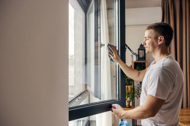 istock A happy man is cleaning window at his apartment. 1791242247