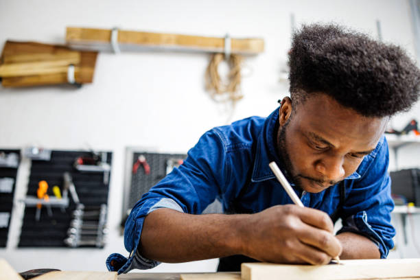 istock African American carpenter measures board for new products 1791244212
