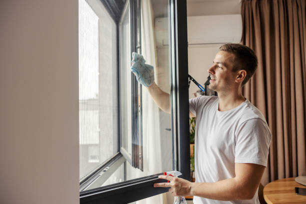 istock A happy young man is doing chores at home. He is cleaning window. 1791244608