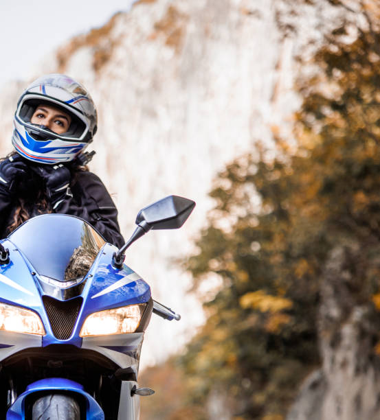 istock Female biker adjusting crash helmet 1791247449