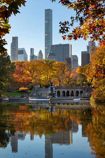 Central Park in autumn with Bethesda Terrace and Midtown skyscrapers. Manhattan, New York City