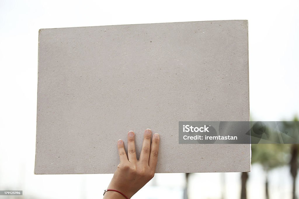 Blank Paper Left hand is holding blank paper. Civilian Stock Photo