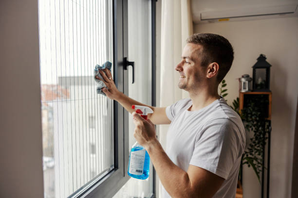 istock A man is wiping window at home by using detergent and rag. 1791252731