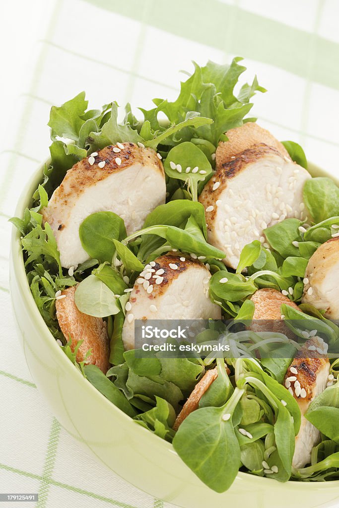 Delicious chicken salad. Delicious salad with chicken pieces with sesame. Healthy eating concept. Bowl Stock Photo
