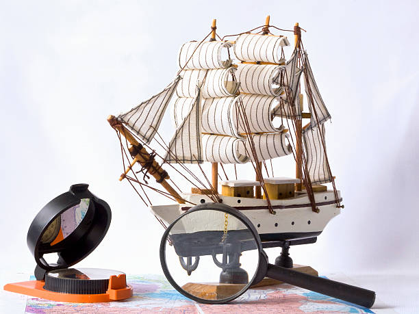 istock Yacht, a compass and magnifying glass on the map 179125829