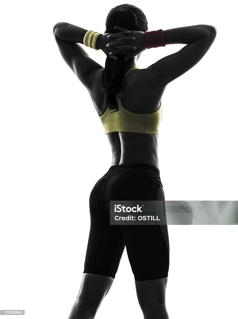 woman exercising fitness arms behind head silhouette rear view one  woman exercising fitness workout arms behind head  rear view in silhouette  on white background Adult Stock Photo