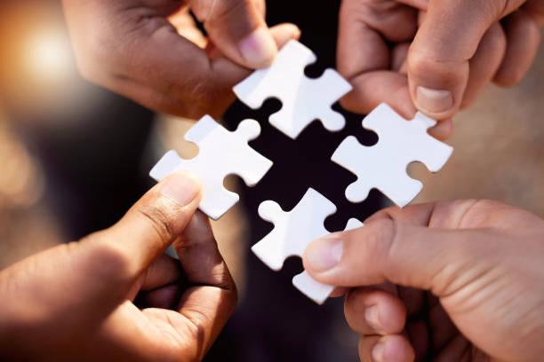 istock Group hands with puzzle for solution, teamwork and workflow goals, achievement and success in closeup. Team building game, project development and people for problem solving, synergy or collaboration 1791262793
